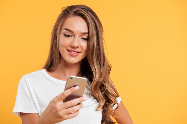 Portrait of a young pretty girl using mobile phone