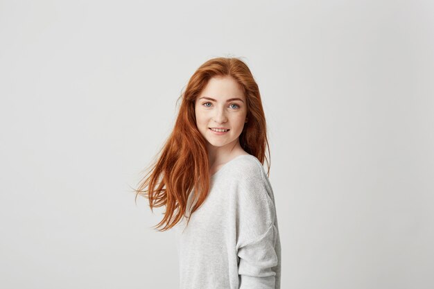 Portrait of young pretty girl with beautiful foxy hair smiling .