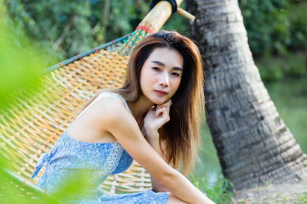 Portrait young pretty woman sitting in hammock