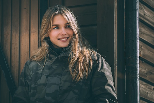 Portrait Young pretty woman in winter in a log cabin in the snow