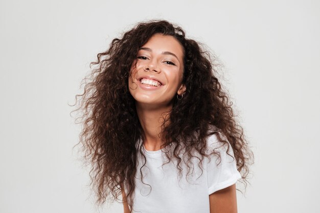 Portrait of a young pretty woman with long curly hair