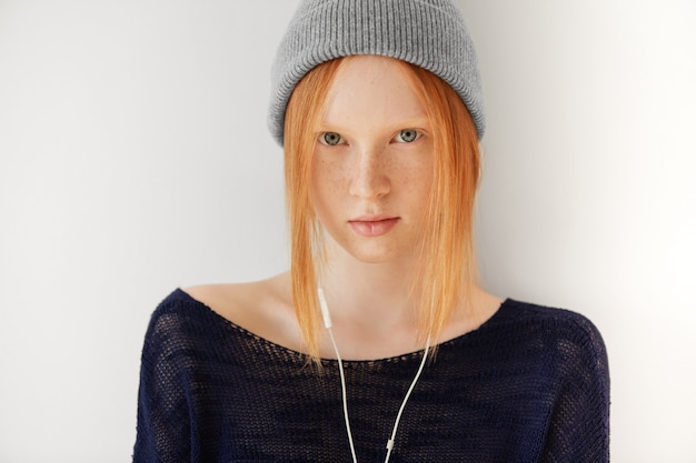 Free Photo portrait of young red-haired woman with headphones