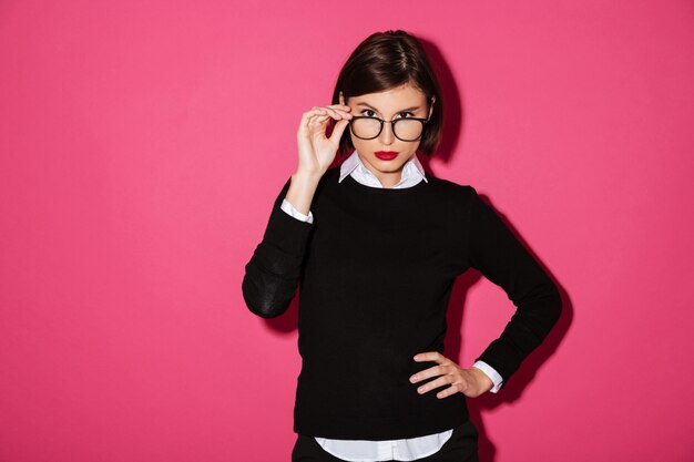 Portrait of a young serious businesswoman in eyeglasses