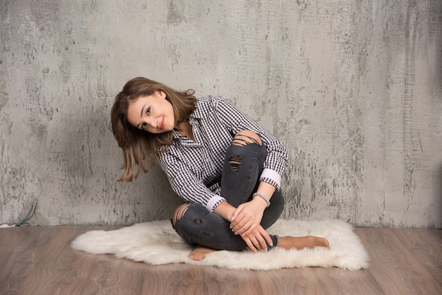 Free photo portrait of a young smiling pretty girl in plaid shirt posing .