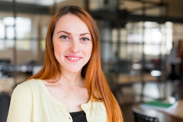 Portrait of young smiling woman looking at camera