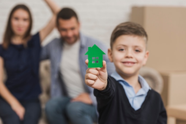 Portrait of young son holding toy