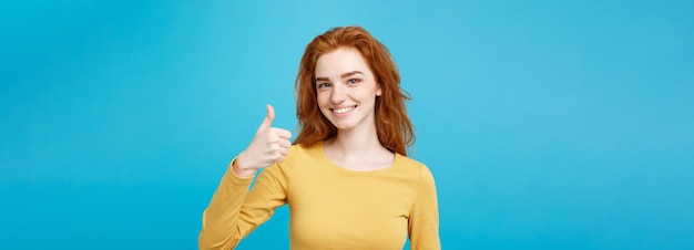 Free photo portrait of young stylish freckled girl laughing with showing thumps up at camera copy space