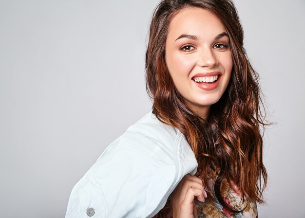 Portrait of young stylish laughing model in colorful casual summer clothes with natural makeup