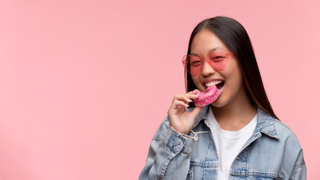 Portrait of young teenage girl eating a donut