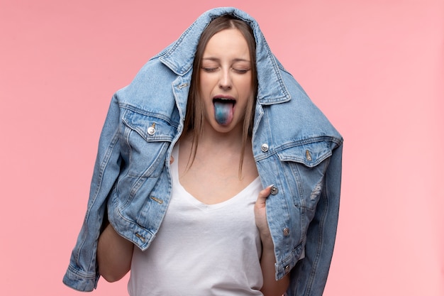 Portrait of young teenage girl showing her blue tongue