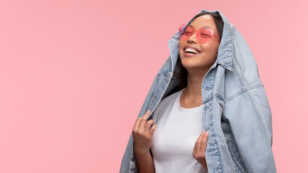 Portrait of young teenage girl with sunglasses and jean jacket