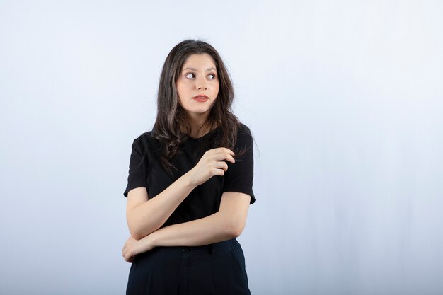 Portrait of young woman in black outfit looking at somewhere.