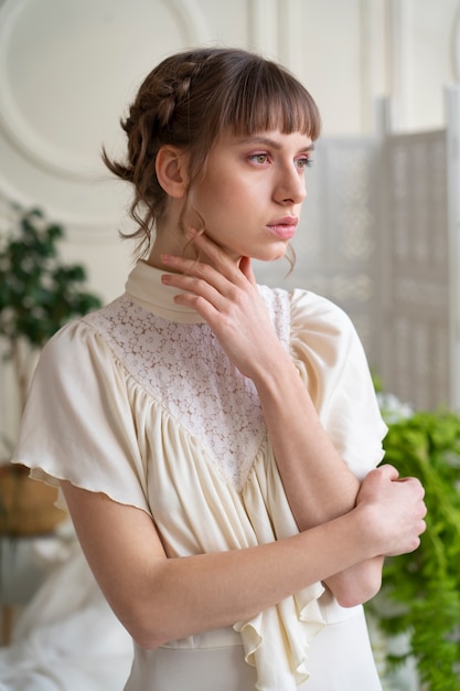 Free Photo portrait of young woman in boho dress with romantic garden aesthetic and vegetation