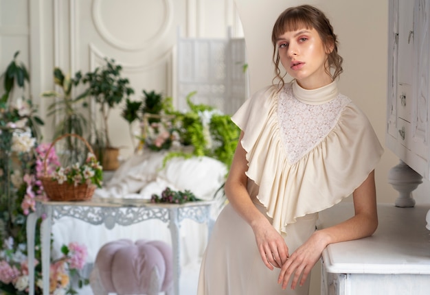 Free Photo portrait of young woman in boho dress with romantic garden aesthetic and vegetation