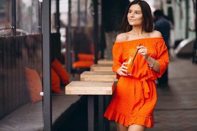 Portrait of a young woman drinking juice