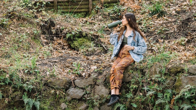 Free Photo portrait of young woman in forest