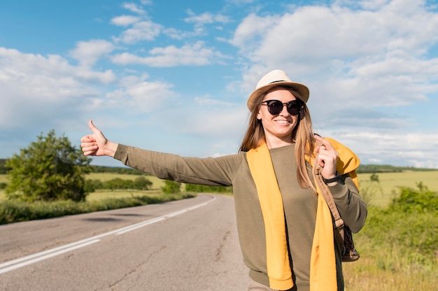 Portrait of young woman hitchhiking