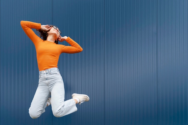 Free photo portrait young woman jumping