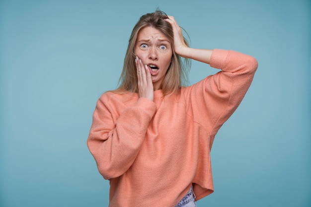 Portrait of a young woman looking surprised