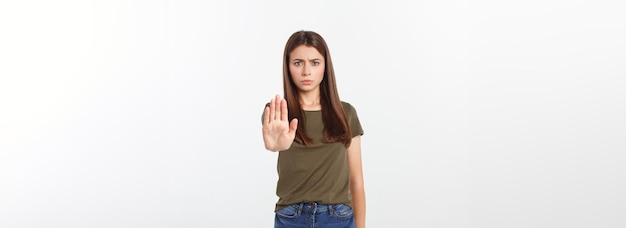 Portrait of young woman making stop sign in front of the camera