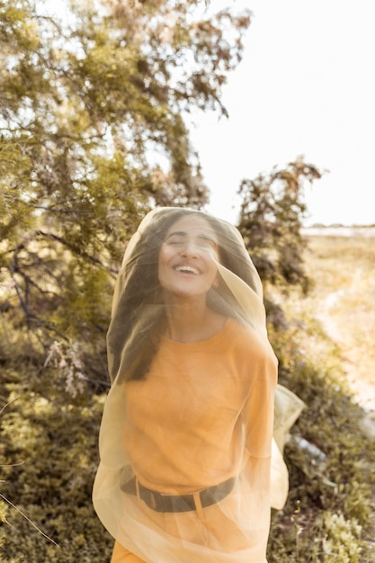 Free Photo portrait of young woman in nature