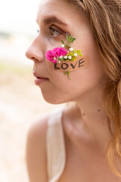 Free photo portrait of young woman posing confidently outdoors with flowers