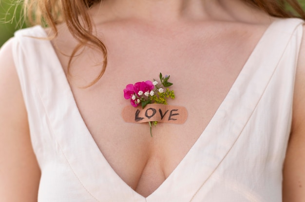 Portrait of young woman posing confidently outdoors with flowers