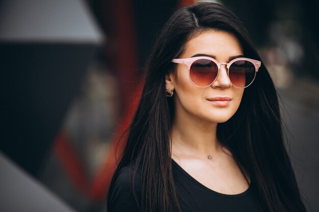 Portrait of a young woman posing outside