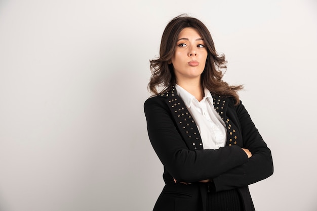 Portrait of young woman posing on white.