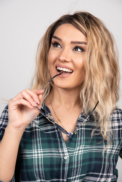 Portrait of young woman posing with stylish glasses. 