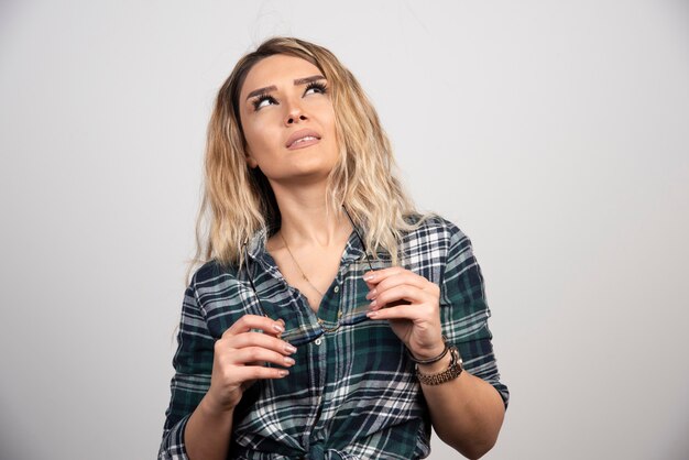 Portrait of young woman posing with stylish glasses. 