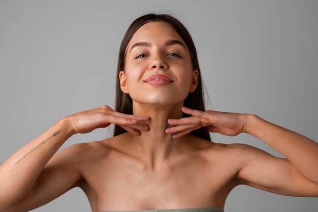 Portrait of young woman practicing facial yoga for youth