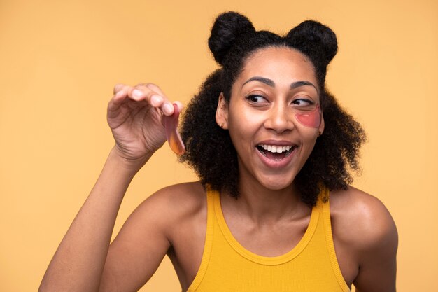 Portrait of a young woman removing her under-eye patches