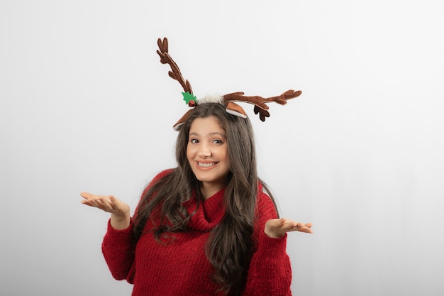 Portrait of a young woman shrugging shoulders and looking at camera. 