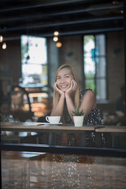 Portrait of young woman smiling in coffee shop cafe