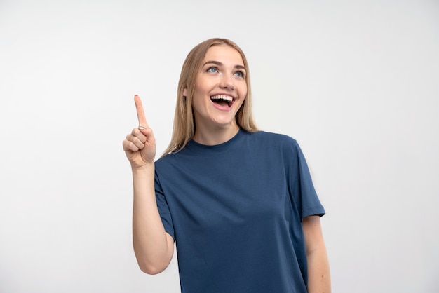 Portrait of a young woman smiling and pointing