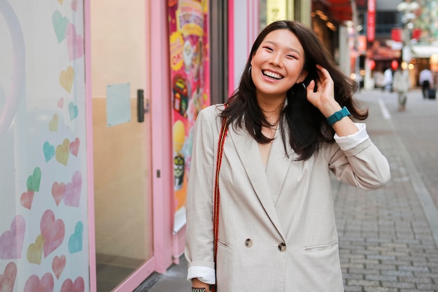 Free Photo portrait of young woman smiling on the street