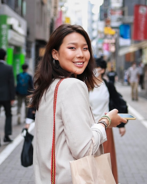 Portrait of young woman smiling on the street