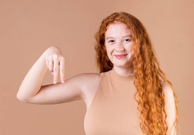 Portrait of a young woman teaching sign language