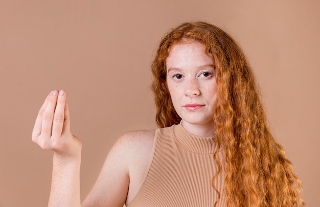 Portrait of a young woman teaching sign language