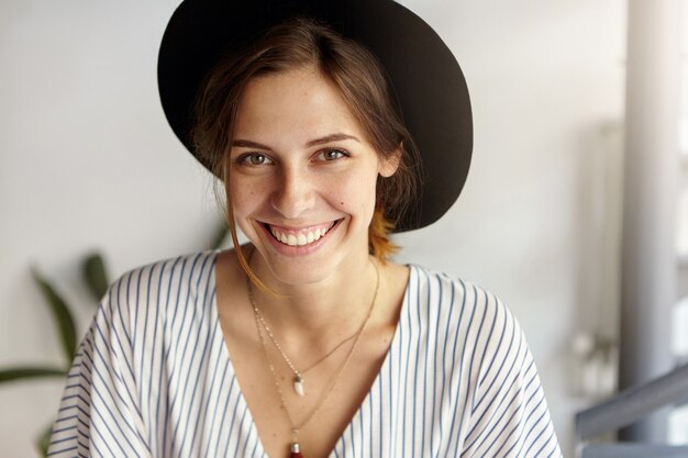 Portrait of young woman wearing big hat