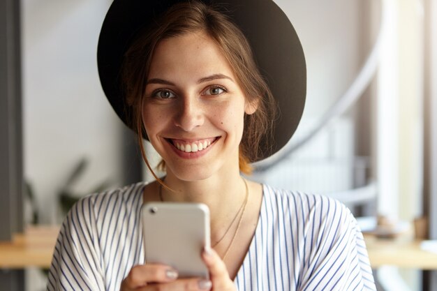 Portrait of young woman wearing big hat