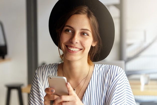 Portrait of young woman wearing big hat