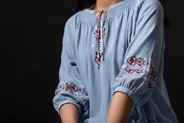 Portrait of young woman wearing embroidered shirt