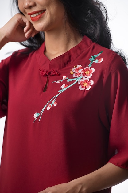 Portrait of young woman wearing embroidered shirt