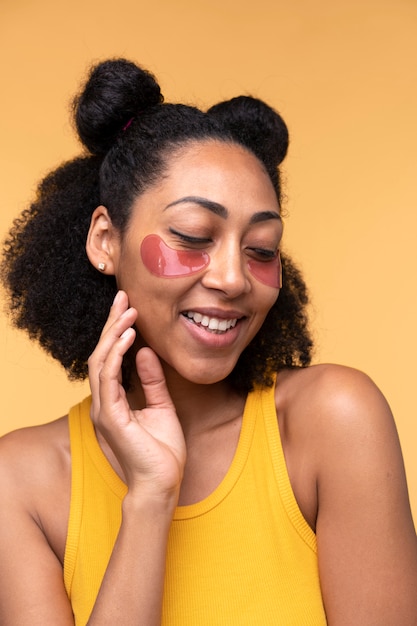 Portrait of a young woman wearing under-eye patches and keeping her eyes closed