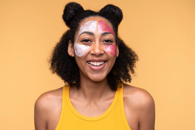 Portrait of a young woman wearing moisturizer and face mask