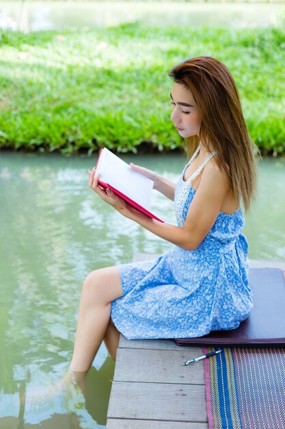 Portrait young woman with diary in park