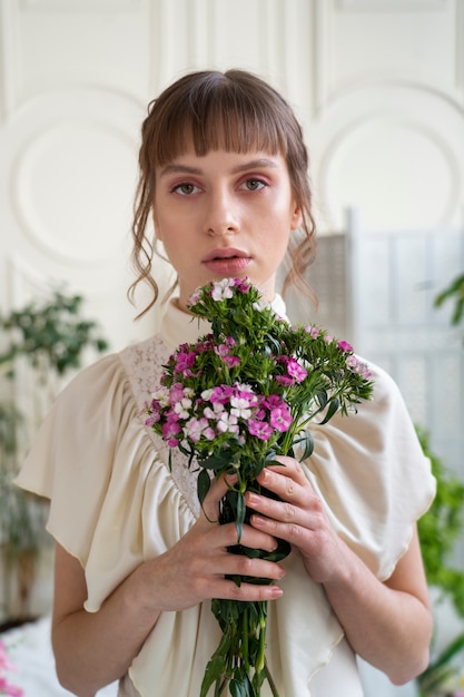 Portrait of young woman with flowers wearing a boho chic dress