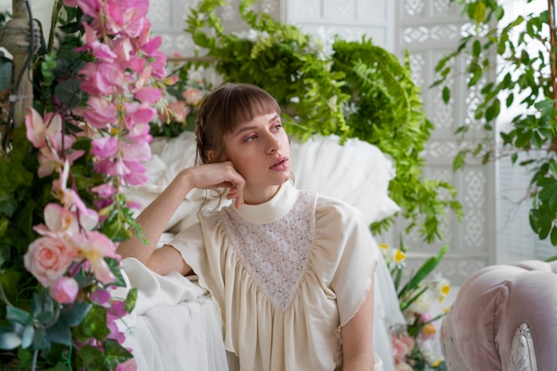 Free photo portrait of young woman with flowers wearing a boho chic dress